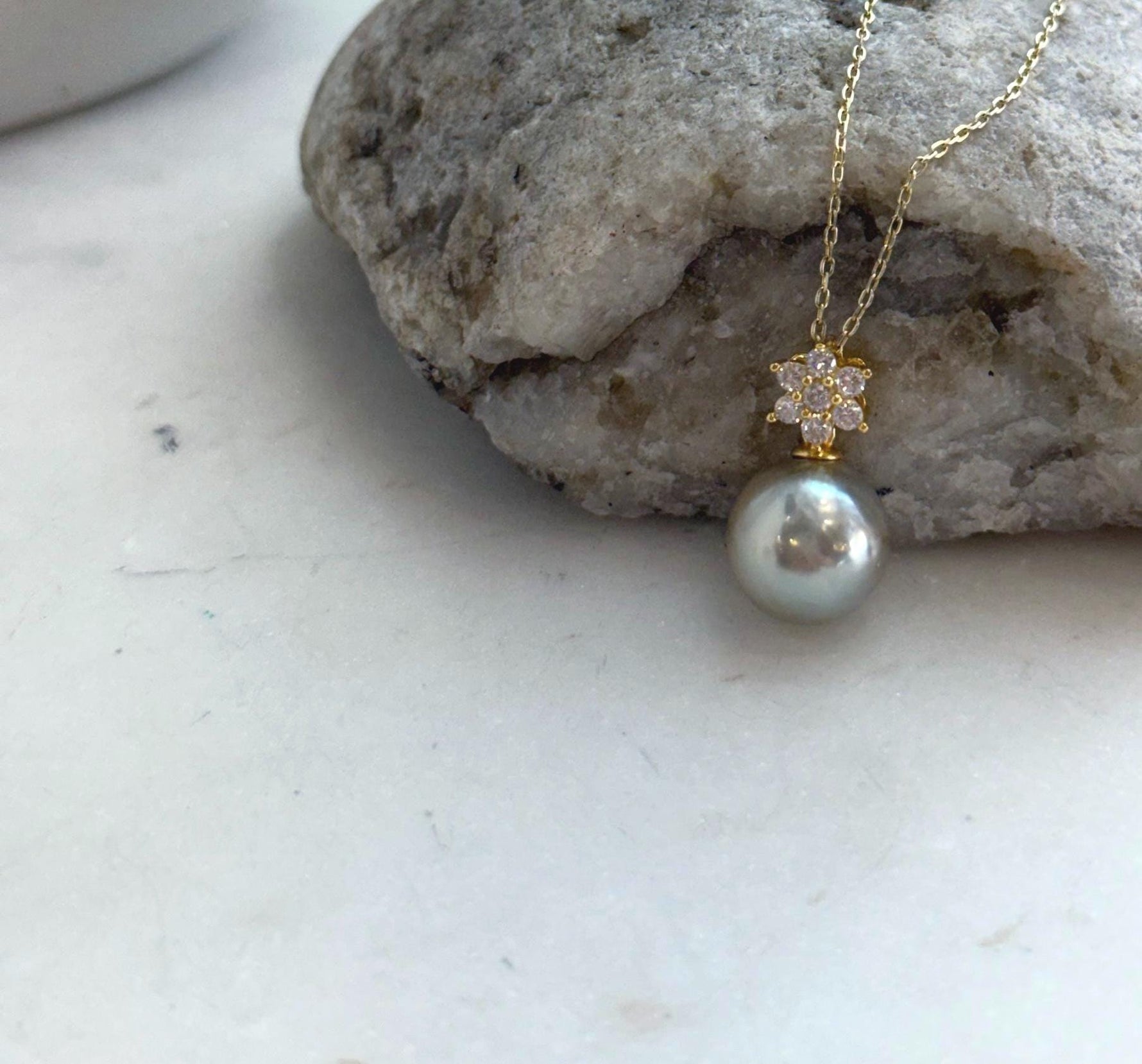 Rare silver pistachio Tahitian pearl pendant displayed on a delicate necklace chain.