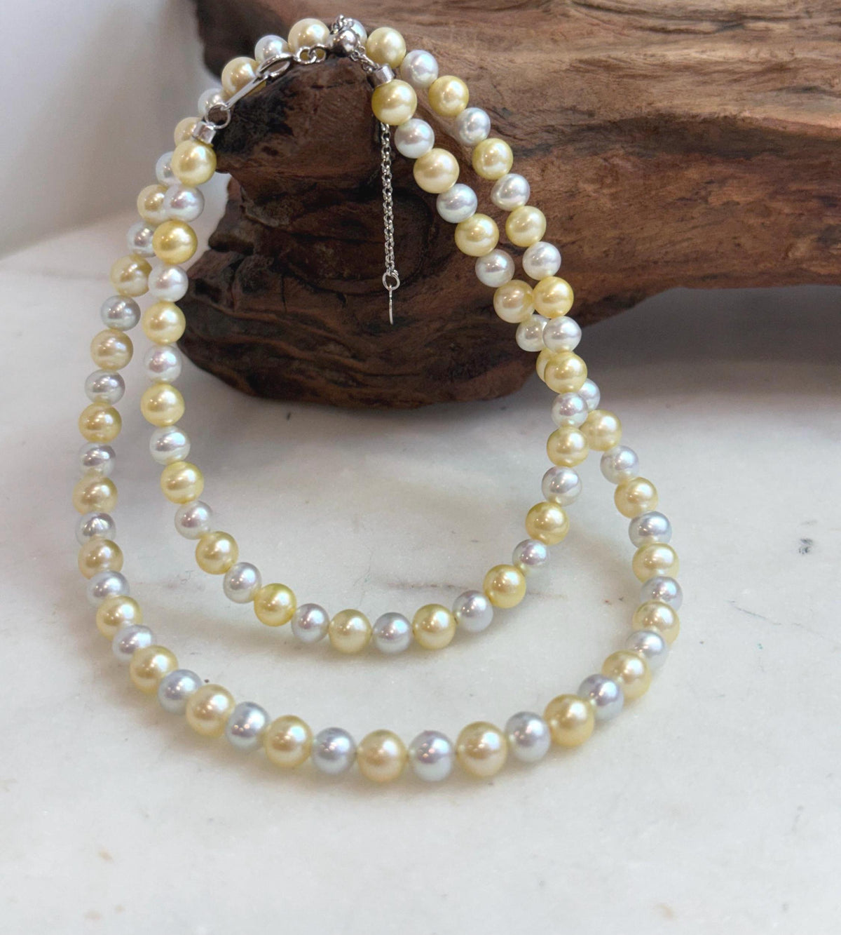 Dainty genuine pearl necklace with small golden and silver freshwater pearls.