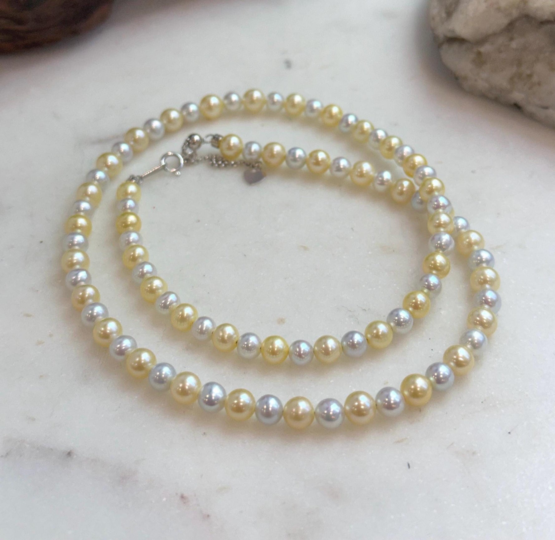 Elegant freshwater pearl strand featuring luminous golden and silvery tones.