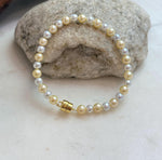 Elly’s 4.3–5.5mm golden silver freshwater pearl bracelet with mirror luster.
