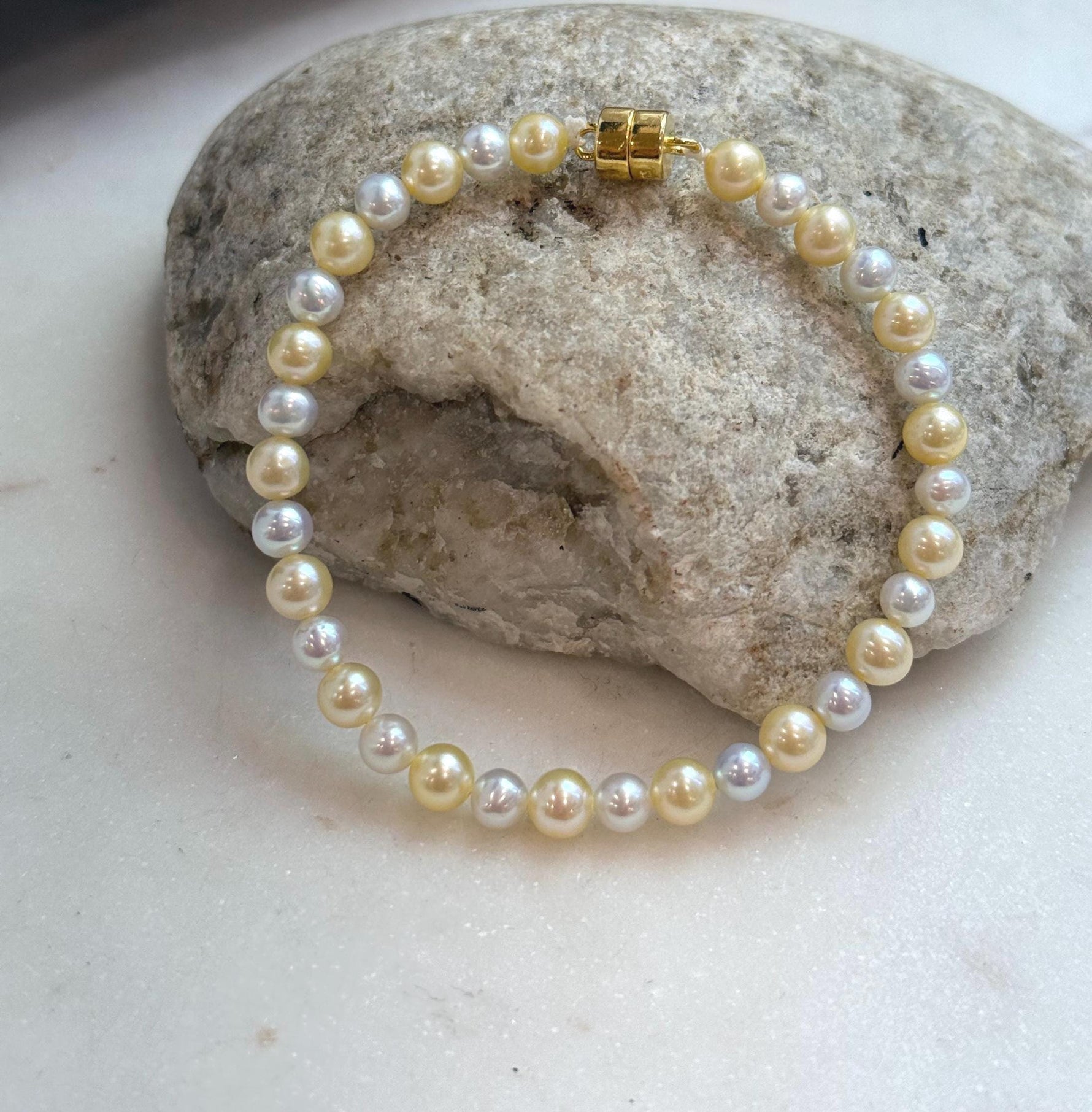 Elegant golden silver pearl strand bracelet made with genuine freshwater pearls.