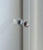 Gift-ready Tahitian platinum pearl stud earrings with mirror-like luster and sterling silver settings.