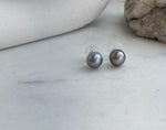Gift-ready Tahitian platinum pearl stud earrings with mirror-like luster and sterling silver settings.