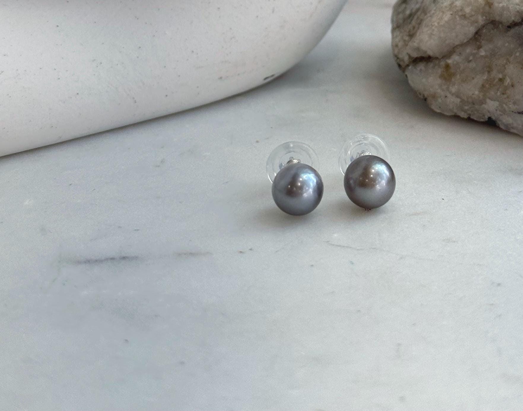 Gift-ready Tahitian platinum pearl stud earrings with mirror-like luster and sterling silver settings.
