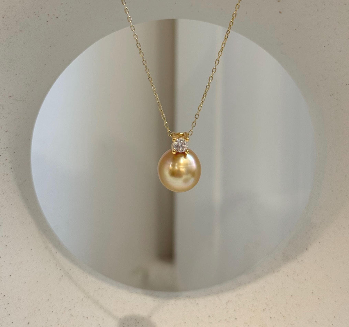 Close-up of 10.7mm deep tea gold South Sea pearl showing its beautiful mirror-like luster.