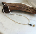 White freshwater pearl strand with green and dark Tahitian pearls and golden South Sea pearl pendant.