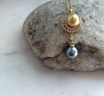 Two premium saltwater pearls in golden and dark Tahitian tones on a minimalist S925 silver setting.