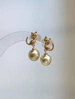 Genuine 9.2mm South Sea golden pearl earrings featuring a cute cat design in S925 sterling silver.