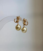 Close-up of 9.2mm genuine South Sea golden pearls showing their rich ultra gold color and extreme reflective luster.