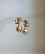 Close-up of 9.2mm genuine South Sea golden pearls showing their rich ultra gold color and extreme reflective luster.