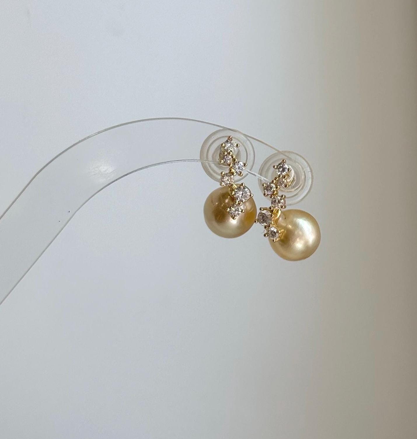 Genuine South Sea pearl earrings featuring rich golden color and brilliant shine.