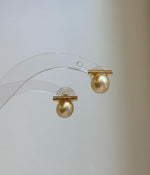 Genuine South Sea golden pearl drop earrings featuring a modern balanced design.