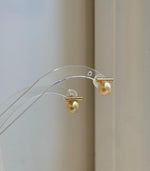 Minimalist 8.8mm golden pearl earrings with beautiful high-luster saltwater pearls.