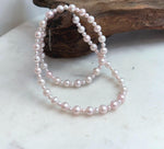 Genuine pink pearl necklace with graduated pearl sizes and an S925 sterling silver finish.