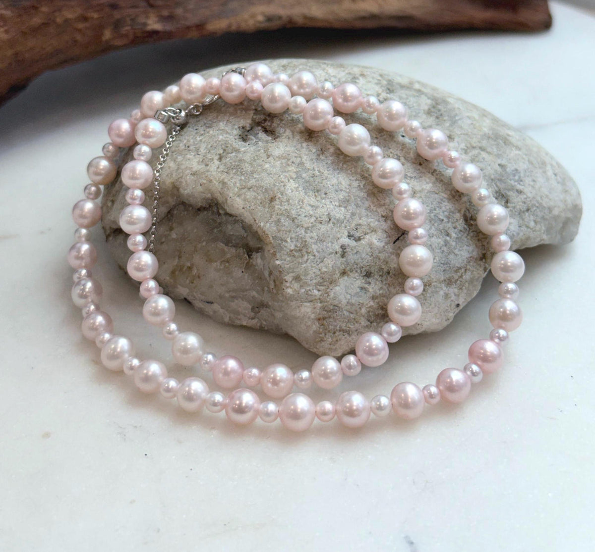 Elegant 18.7 inch pale pink freshwater pearl strand necklace with luminous mirror luster.