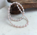 Delicate pale pink pearl strand necklace with lustrous genuine pearls for elegant everyday wear.