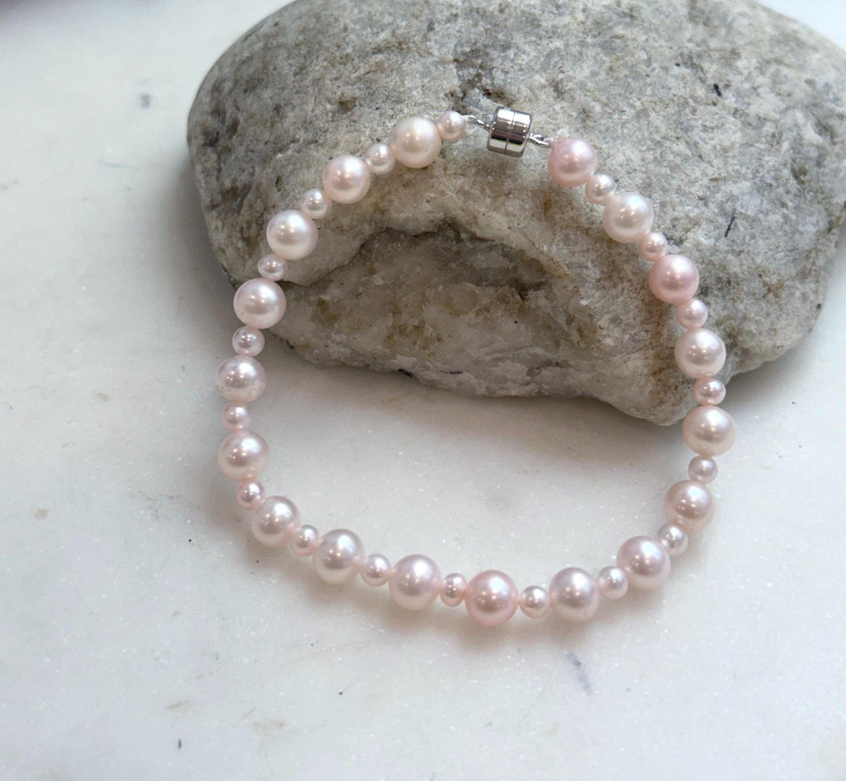 5. 5–6.5mm graduated pink pearl bracelet made with genuine freshwater pearls and sterling silver.