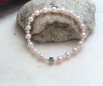 Delicate pale pink pearl bracelet with lustrous genuine freshwater pearls for elegant everyday wear.