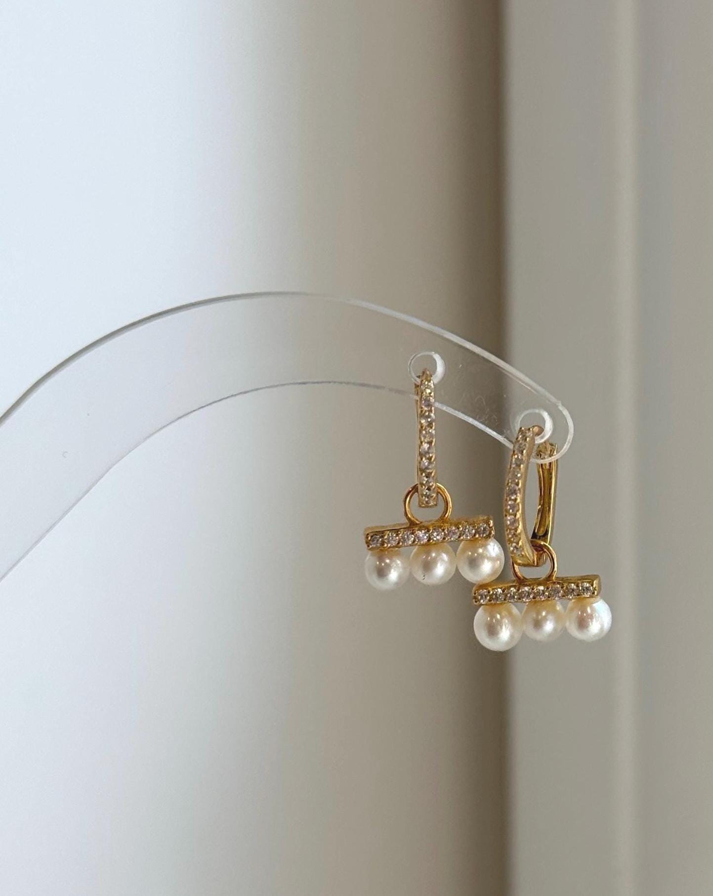 Elly’s 4-4.4mm white freshwater pearl hoop earrings in sterling silver.