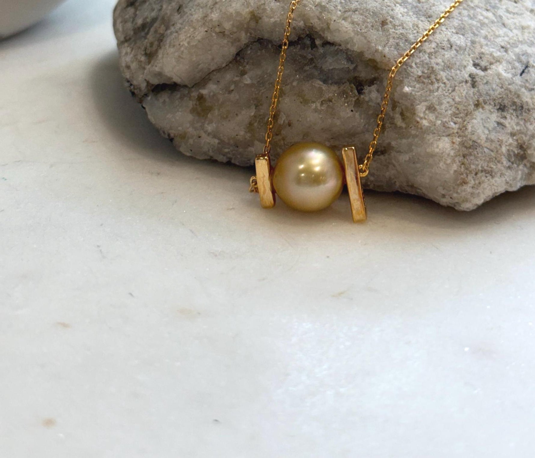 Elegant South Sea golden pearl pendant displayed on a sterling silver necklace