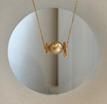 Elegant South Sea golden pearl pendant displayed on a sterling silver necklace