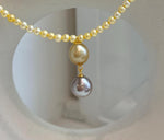 Luxury genuine pearl necklace with contrasting Tahitian and warm golden pearl colors.