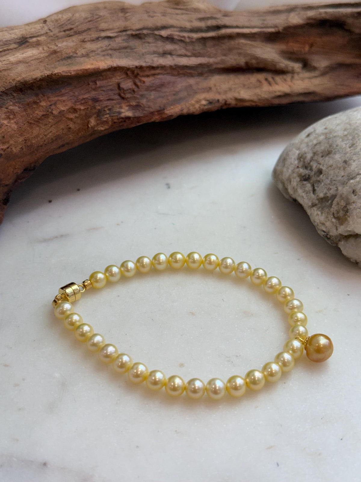 Genuine golden pearl jewelry featuring lustrous 7.6mm South Sea saltwater pearls.