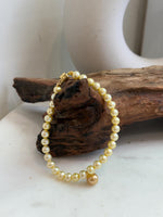 Close-up of 7.6mm deep tea golden South Sea pearls with beautiful mirror luster.