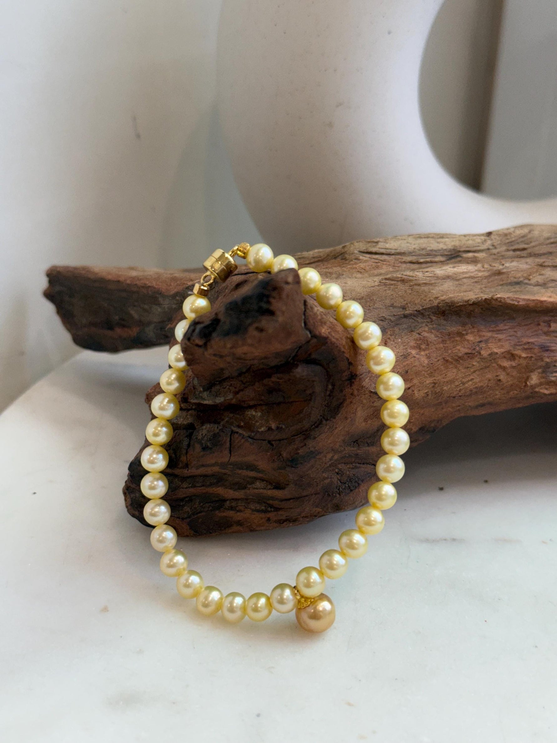 Close-up of 7.6mm deep tea golden South Sea pearls with beautiful mirror luster.