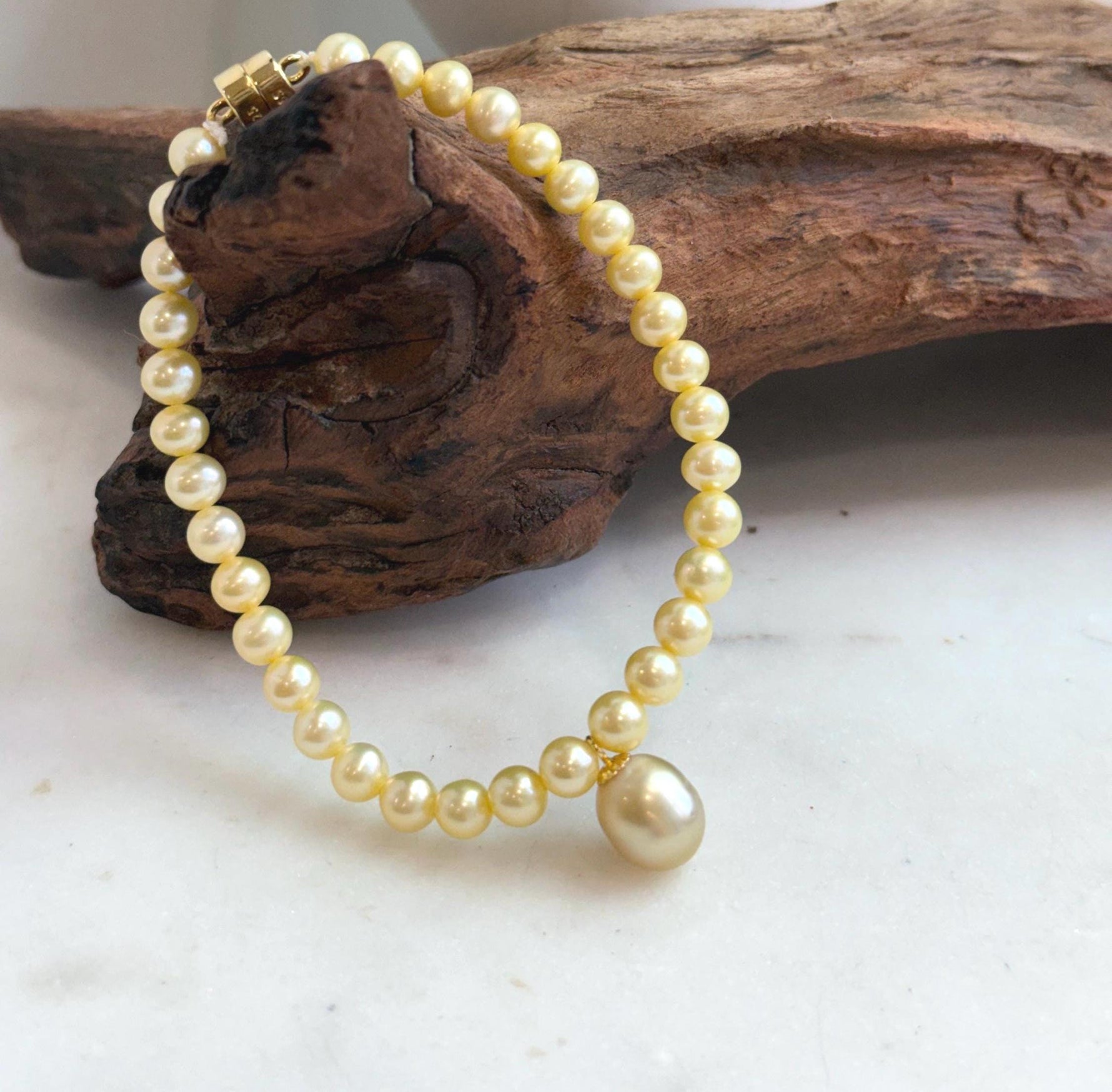 Fine pearl jewelry featuring a genuine 9.1mm golden South Sea pearl and sterling silver.