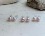 Close-up of 9.5mm pale pink Edison pearls showing their beautiful natural color and reflective luster.