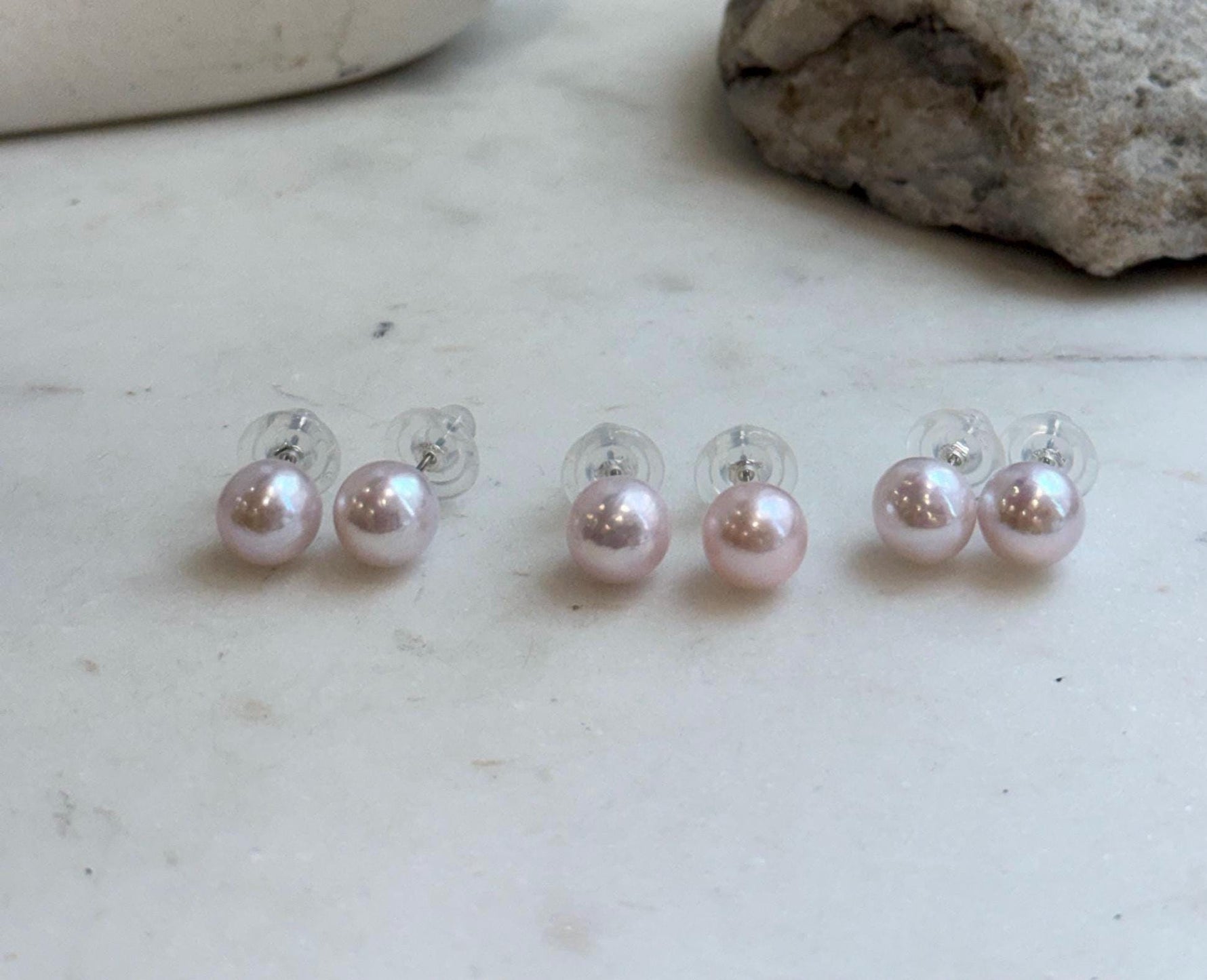 Close-up of 9.5mm pale pink Edison pearls showing their beautiful natural color and reflective luster.