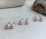 Minimalist pale pink pearl stud earrings crafted with genuine freshwater pearls and sterling silver.