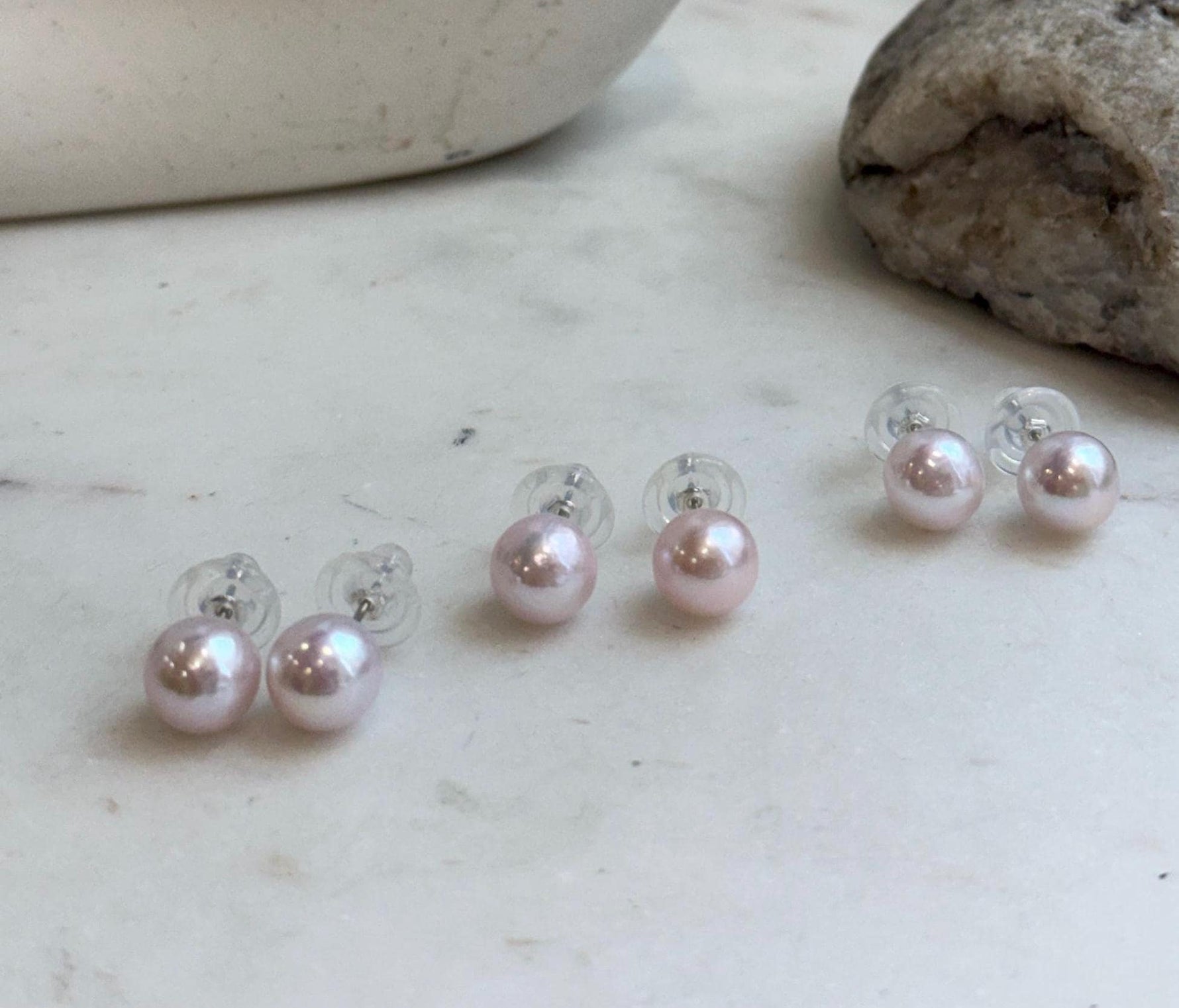 Minimalist pale pink pearl stud earrings crafted with genuine freshwater pearls and sterling silver.