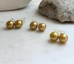 Genuine freshwater Edison golden pearl earrings featuring large 11.3mm round pearls and high reflective luster.