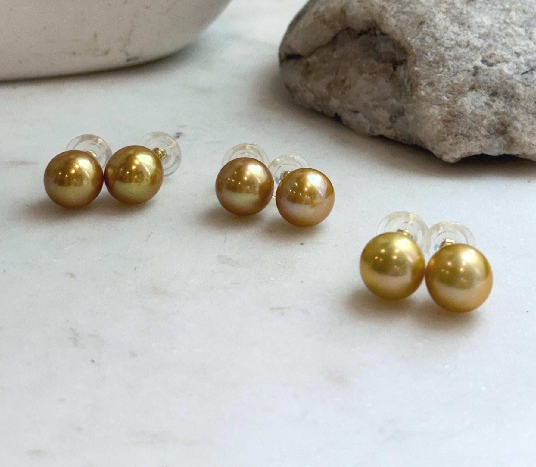 Genuine freshwater Edison golden pearl earrings featuring large 11.3mm round pearls and high reflective luster.