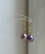 Elegant freshwater pearl drop earrings with natural rose and lavender overtones.