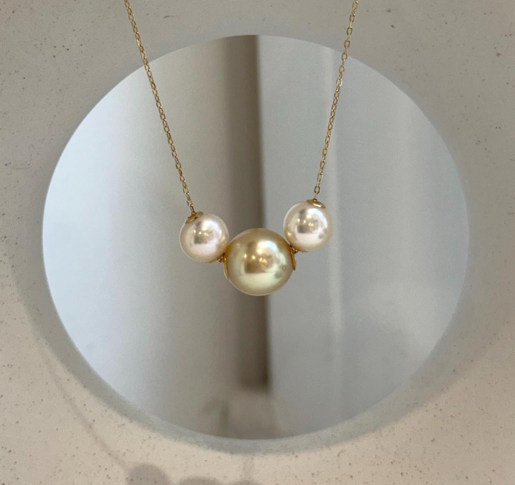Elegant 18K gold pendant with South Sea Golden and Akoya pearls in a floating design.