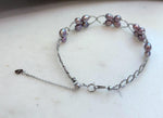 Delicate sterling silver bracelet adorned with 16 genuine Keshi pearls.