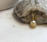Natural South Sea golden pearl with smooth round shape and brilliant mirror finish.