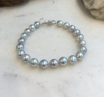 Premium ocean pearl bracelet with brilliant mirror-like shine and sterling silver hardware.
