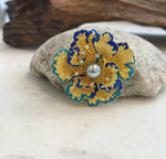 Floral pearl brooch that converts into a pendant necklace.