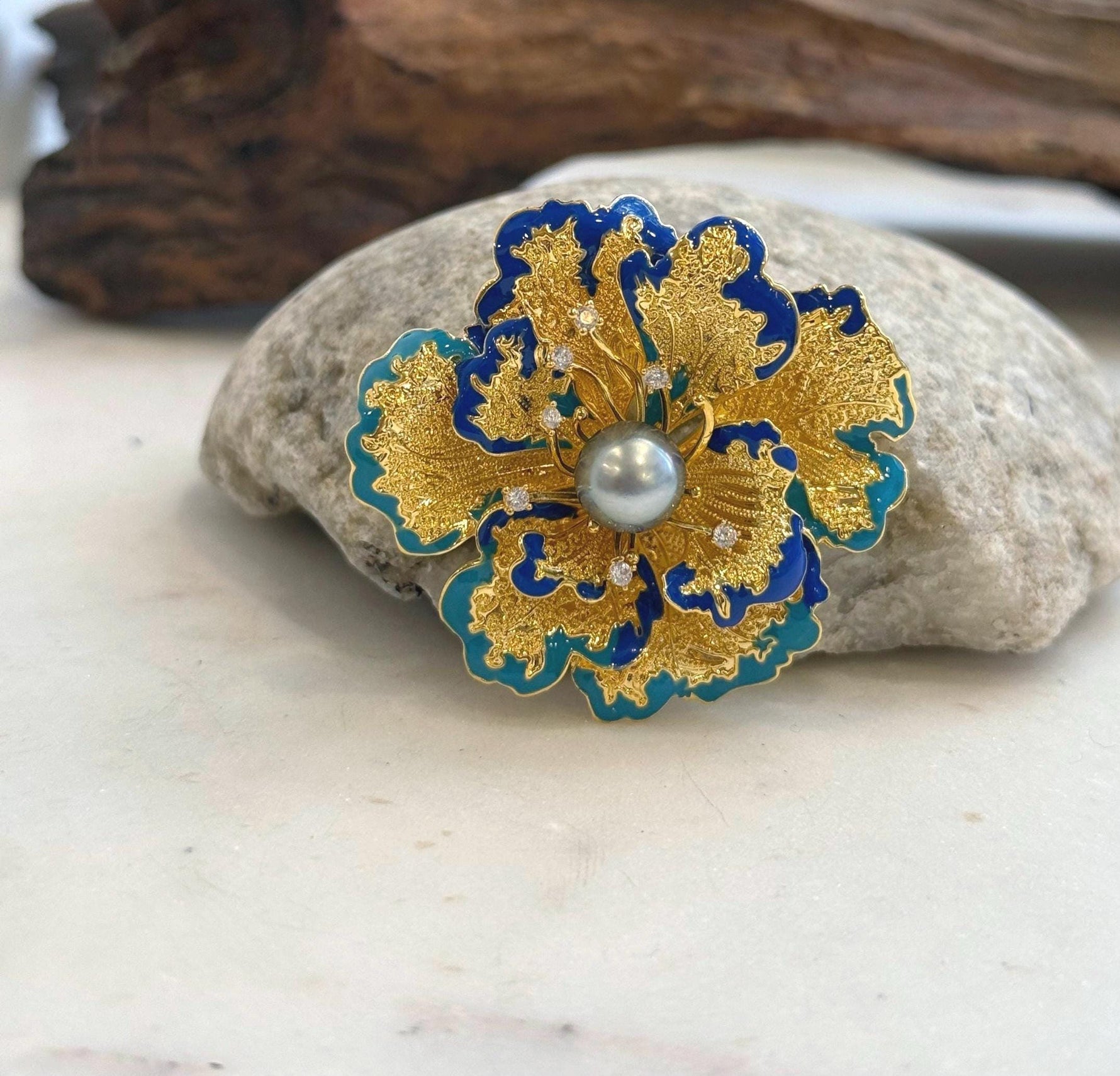 Floral pearl brooch that converts into a pendant necklace.