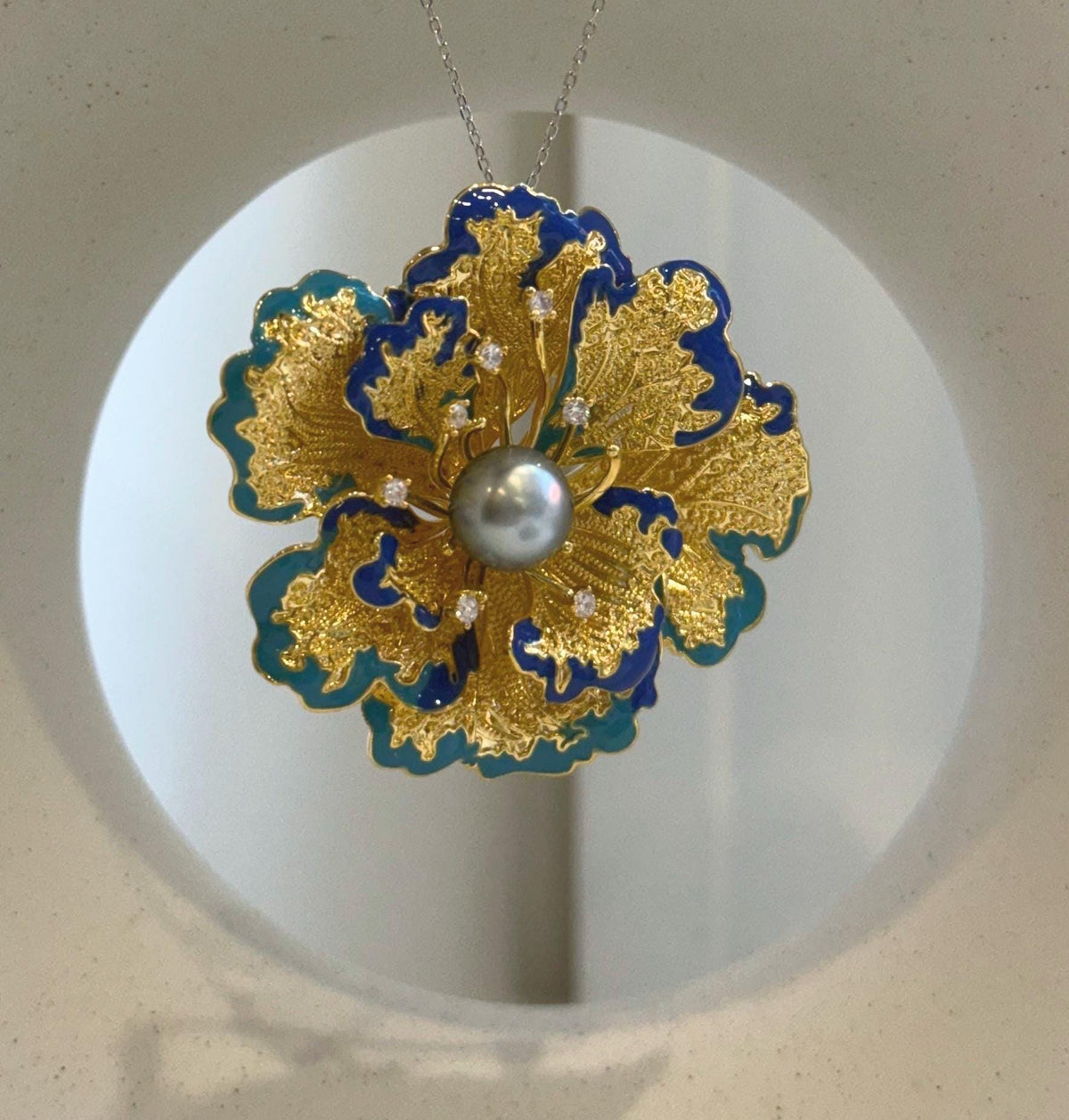 Close-up of genuine Tahitian pearl showing brilliant reflective surface.