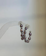 Close-up of genuine 4–5mm purple Keshi pearls with natural shape