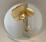 Elegant floral pearl brooch pendant measuring approximately 4.5 × 6.5 cm.