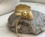 Luxury South Sea pearl flower brooch featuring an extremely lustrous golden pearl.