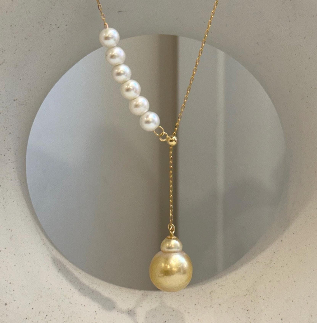 Handmade Y-shaped pearl necklace with genuine golden and white pearls.