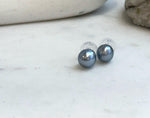 Close-up of 9.3mm platinum Tahitian pearls showing flawless luster