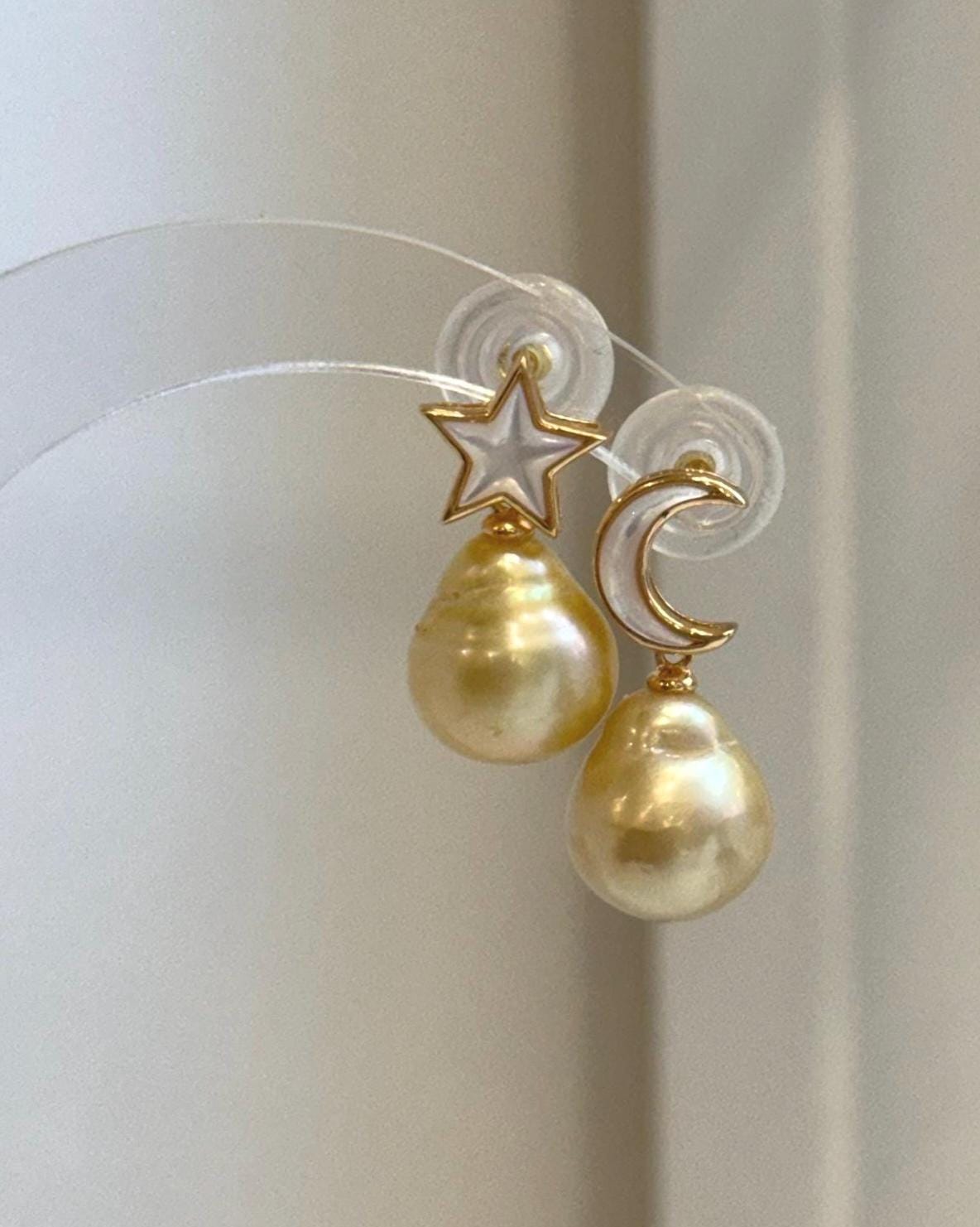 Classic 11.4mm South Sea Golden Pearl stud earrings with celestial star moon design.